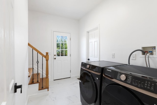 clothes washing area featuring washing machine and clothes dryer