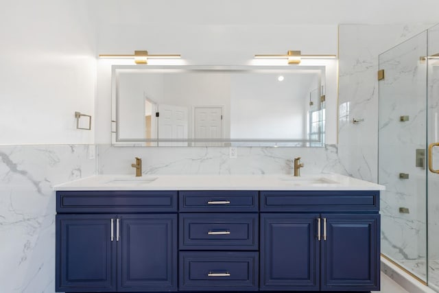 bathroom with vanity, tile walls, and a shower with door