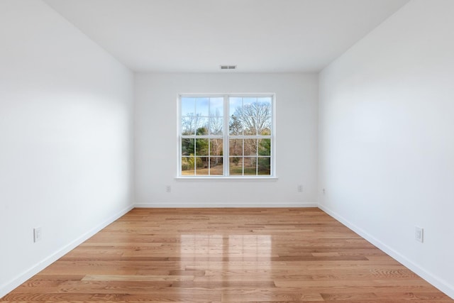 unfurnished room with light wood-type flooring