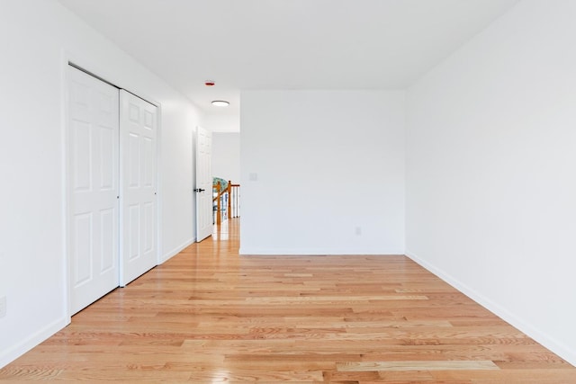 unfurnished bedroom featuring light hardwood / wood-style floors and a closet