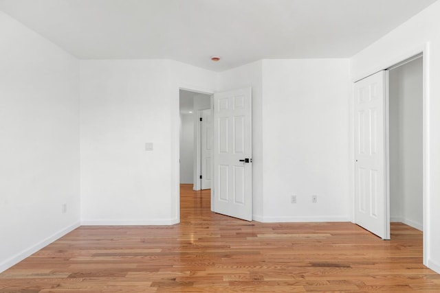 unfurnished bedroom with light wood-type flooring