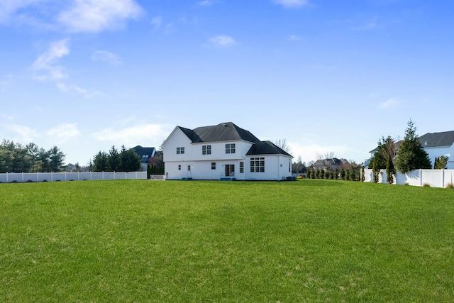 back of house featuring a yard