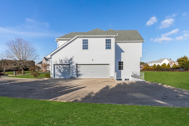 view of home's exterior featuring a garage and a lawn