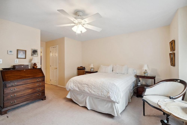 carpeted bedroom with ceiling fan and a closet