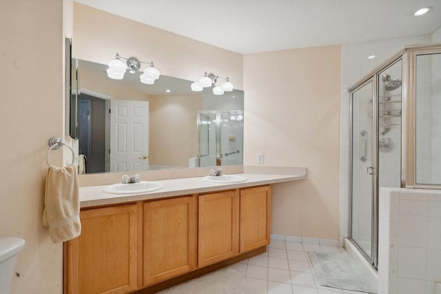 bathroom with toilet, tile patterned floors, vanity, and an enclosed shower