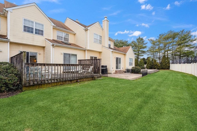 back of property with a wooden deck, central AC, a yard, and a patio