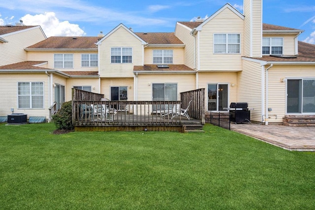 rear view of house featuring a deck, central air condition unit, a patio area, and a yard