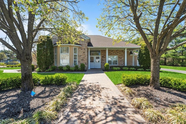 view of front facade with french doors and a front yard