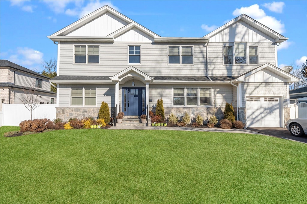 view of front of house with a front lawn and a garage