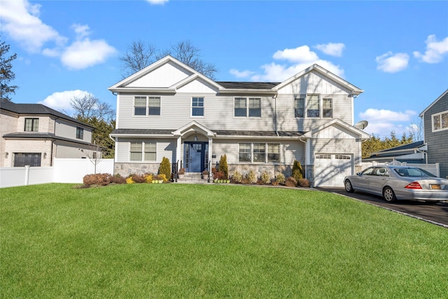 view of front facade featuring a front yard and a garage