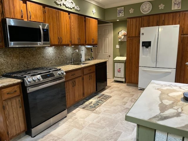 kitchen featuring appliances with stainless steel finishes, decorative backsplash, and sink