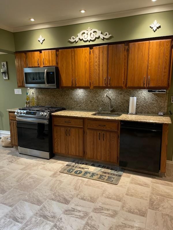 kitchen with stainless steel appliances, sink, backsplash, and crown molding