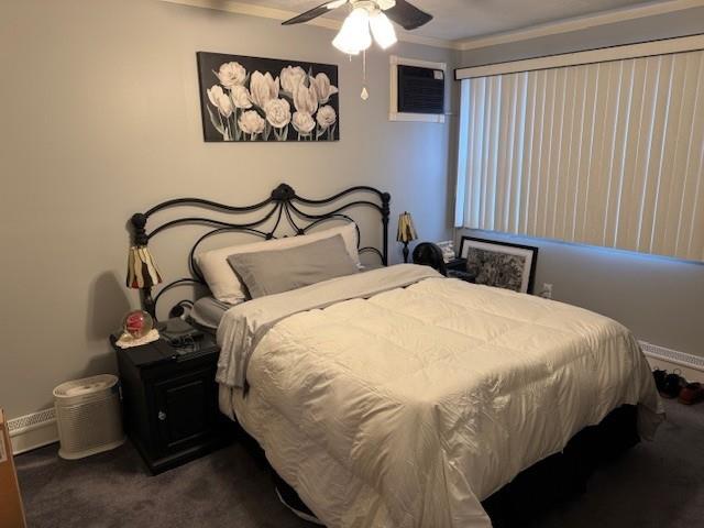 carpeted bedroom featuring ceiling fan, a wall mounted AC, and ornamental molding