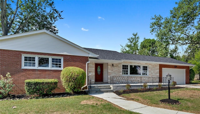 single story home with covered porch, a garage, and a front yard