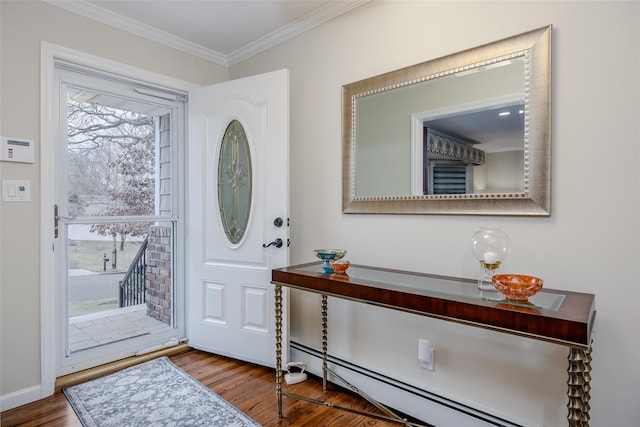 foyer entrance featuring baseboard heating, crown molding, and wood-type flooring