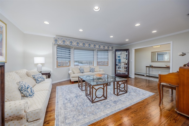 living room with baseboard heating, hardwood / wood-style floors, and crown molding