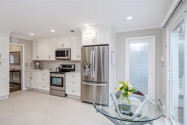 kitchen featuring decorative backsplash, white cabinetry, crown molding, and stainless steel appliances