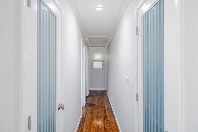 hallway with wood-type flooring and crown molding