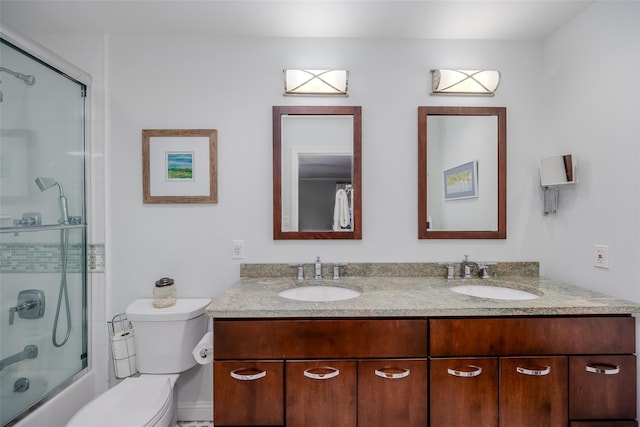 full bathroom featuring enclosed tub / shower combo, toilet, and vanity