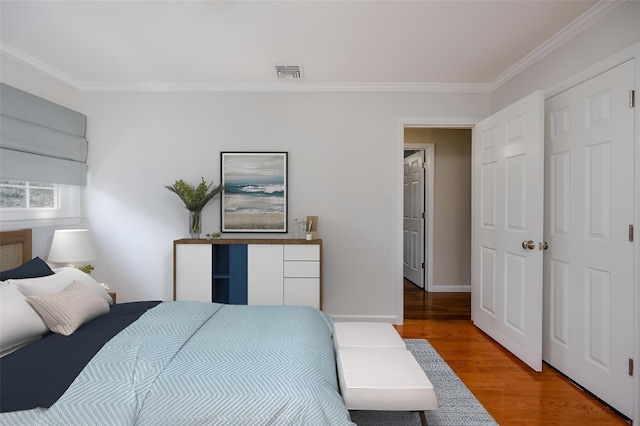 bedroom featuring ornamental molding and wood-type flooring