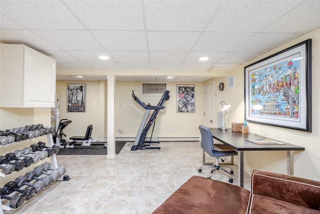 exercise area featuring baseboard heating and a drop ceiling