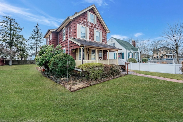 view of front facade with a porch and a front lawn