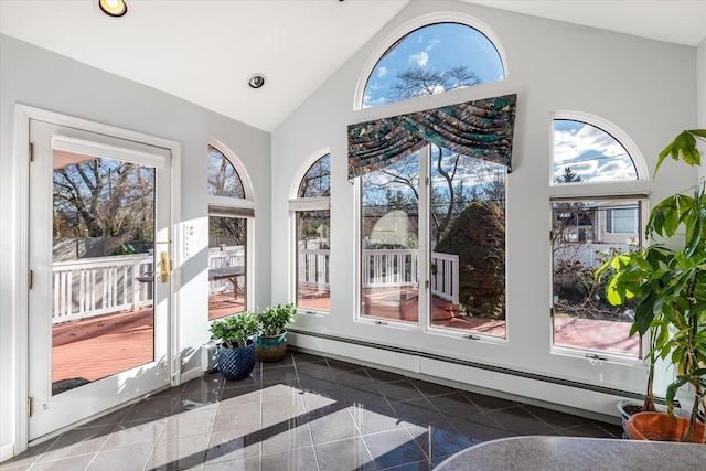 sunroom featuring baseboard heating and vaulted ceiling