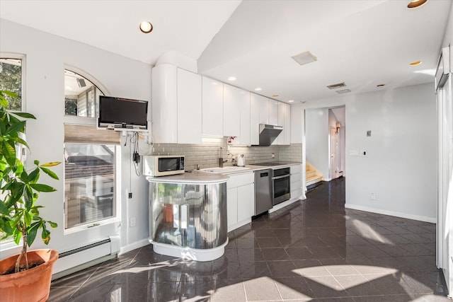 kitchen with stainless steel appliances, decorative backsplash, white cabinets, a baseboard radiator, and sink