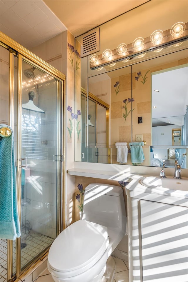 bathroom featuring toilet, an enclosed shower, and tile patterned flooring