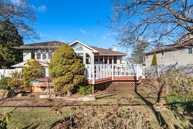 rear view of property featuring a deck