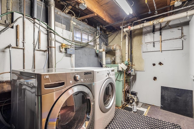 clothes washing area with separate washer and dryer