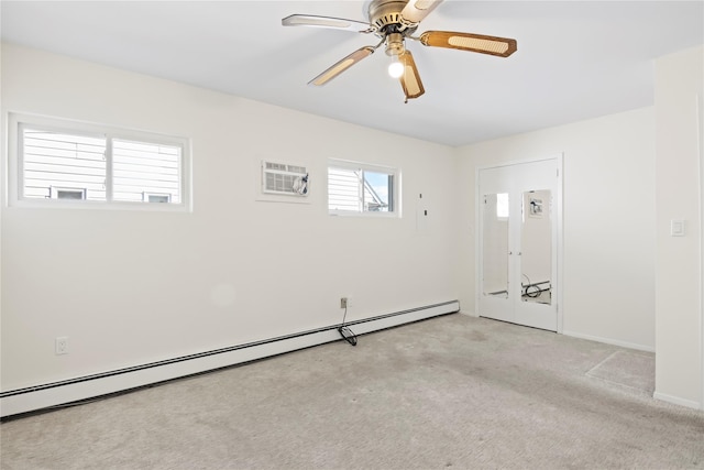 spare room with light carpet, a baseboard heating unit, a wall unit AC, and ceiling fan