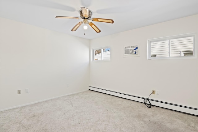 spare room with ceiling fan, light colored carpet, and baseboard heating