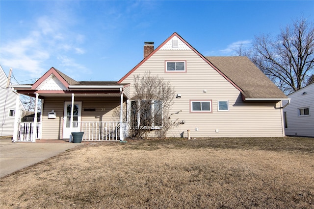 view of front of property with covered porch and a front yard