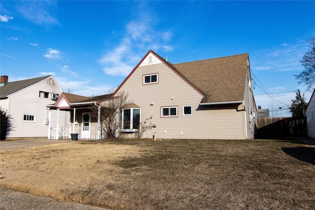 back of house with a lawn and a porch