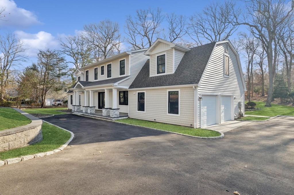 view of front of property with covered porch and a garage