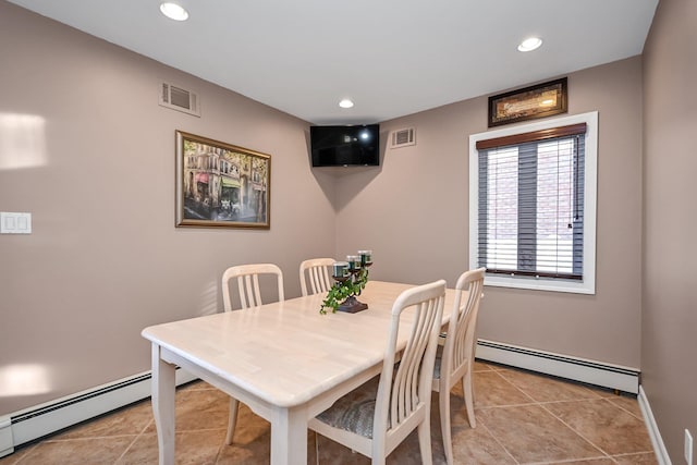 dining area with light tile patterned floors and a baseboard radiator