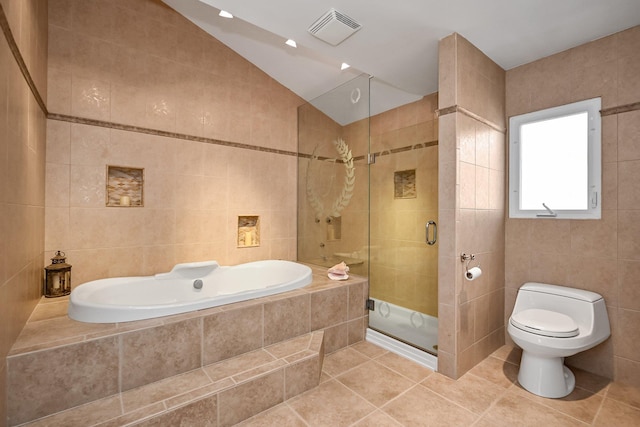 bathroom with toilet, shower with separate bathtub, tile walls, tile patterned floors, and lofted ceiling