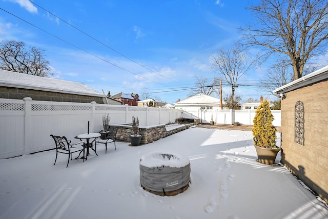 yard layered in snow with a patio