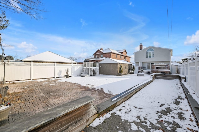 view of snow covered rear of property