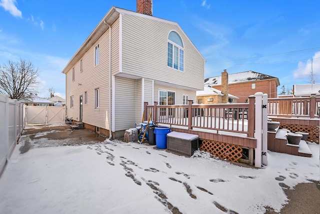 snow covered property with a wooden deck