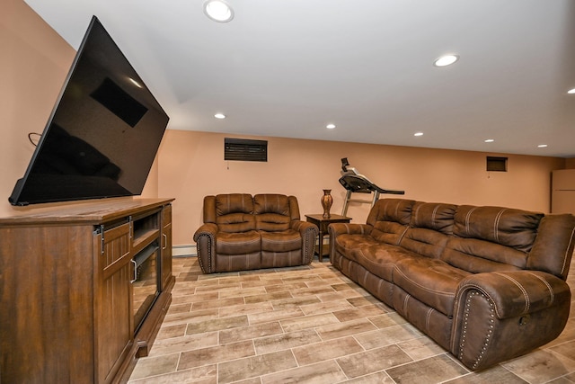 living area featuring recessed lighting and baseboard heating