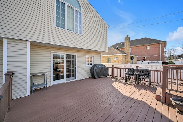 wooden terrace featuring a grill