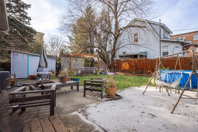 view of patio featuring a storage unit