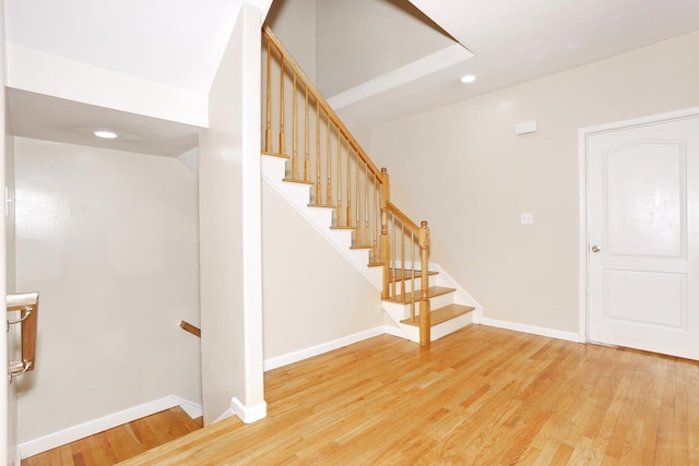 staircase with hardwood / wood-style flooring