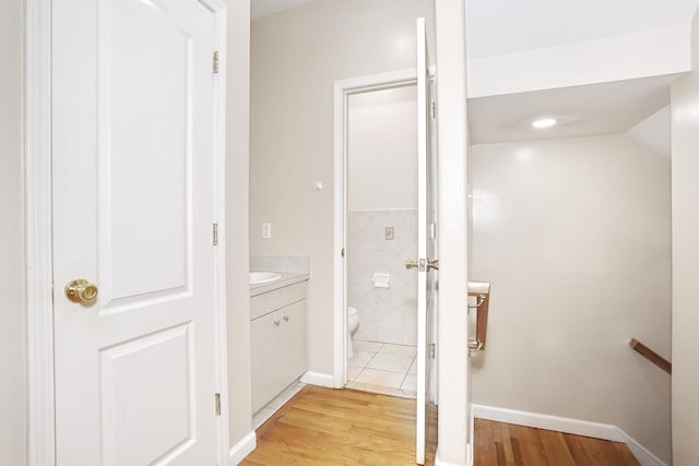 bathroom with toilet, wood-type flooring, and vanity