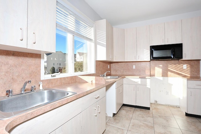 kitchen featuring light tile patterned flooring, decorative backsplash, and sink