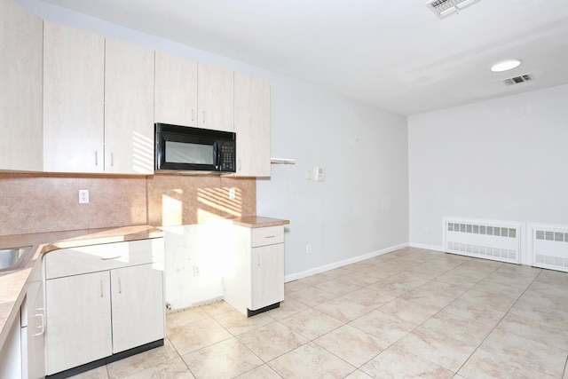 kitchen featuring sink and light tile patterned flooring