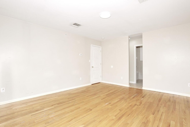 empty room with light hardwood / wood-style flooring