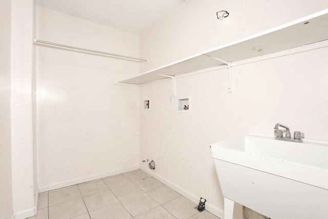 washroom featuring sink, light tile patterned floors, and hookup for a washing machine